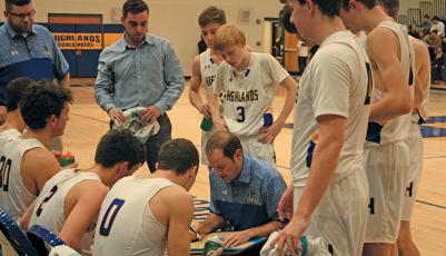 Highlands coach Brett Lamb draws up a play during a timeout against Murphy on Friday night.