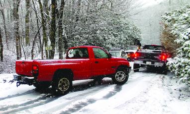 About a dozen vehicles were stranded on NC 106 between Bartram Way and Turtle Pond Road as snow fell on Highlands Friday morning.