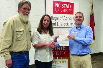 Lori and Daniel Cabe are presented their grant award from Ross Young, WNC AgOptions steering committee leader.