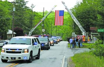 A line of emergency vehicles nearly a mile long escorted Macon County Sheriff’s Office corporal David Head’s body to Scaly Mountain Volunteer Fire Department where a celebration of life service was held on Thursday.