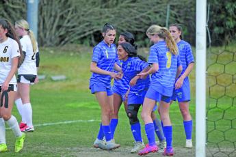 Photo by Christopher Lugo/Staff Highlands freshman Gabriela Diaz gets help from her teammates after scoring a goal on Monday night. 