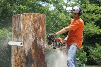 Photo by Christopher Lugo/Staff Chainsaw carver and owner of Extreme Sculpting, Chris Lantz, said his overall goal is to carve large pieces that houses are centered around. 