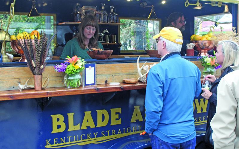 Guests of the Highlands Food and Wine Festival visit the Blade and Bow drink station on Friday afternoon.