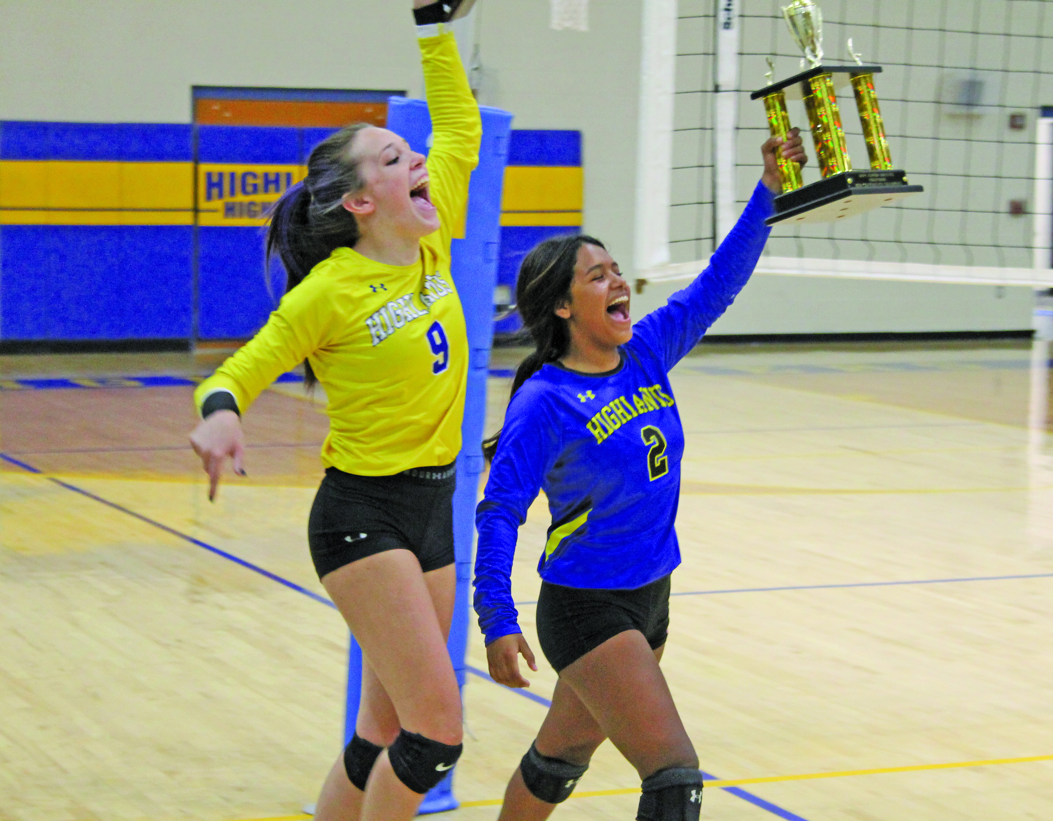 Photo by Christopher Smith/Staff HHS seniors Reese Schmitt and Brandy Zegal lift the conference trophies. 