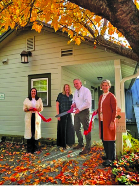 Highlands Chamber director Kaye McHan with Tom and Robyn Hessling at Mountain Construction Engineering’s ribbon cutting. 