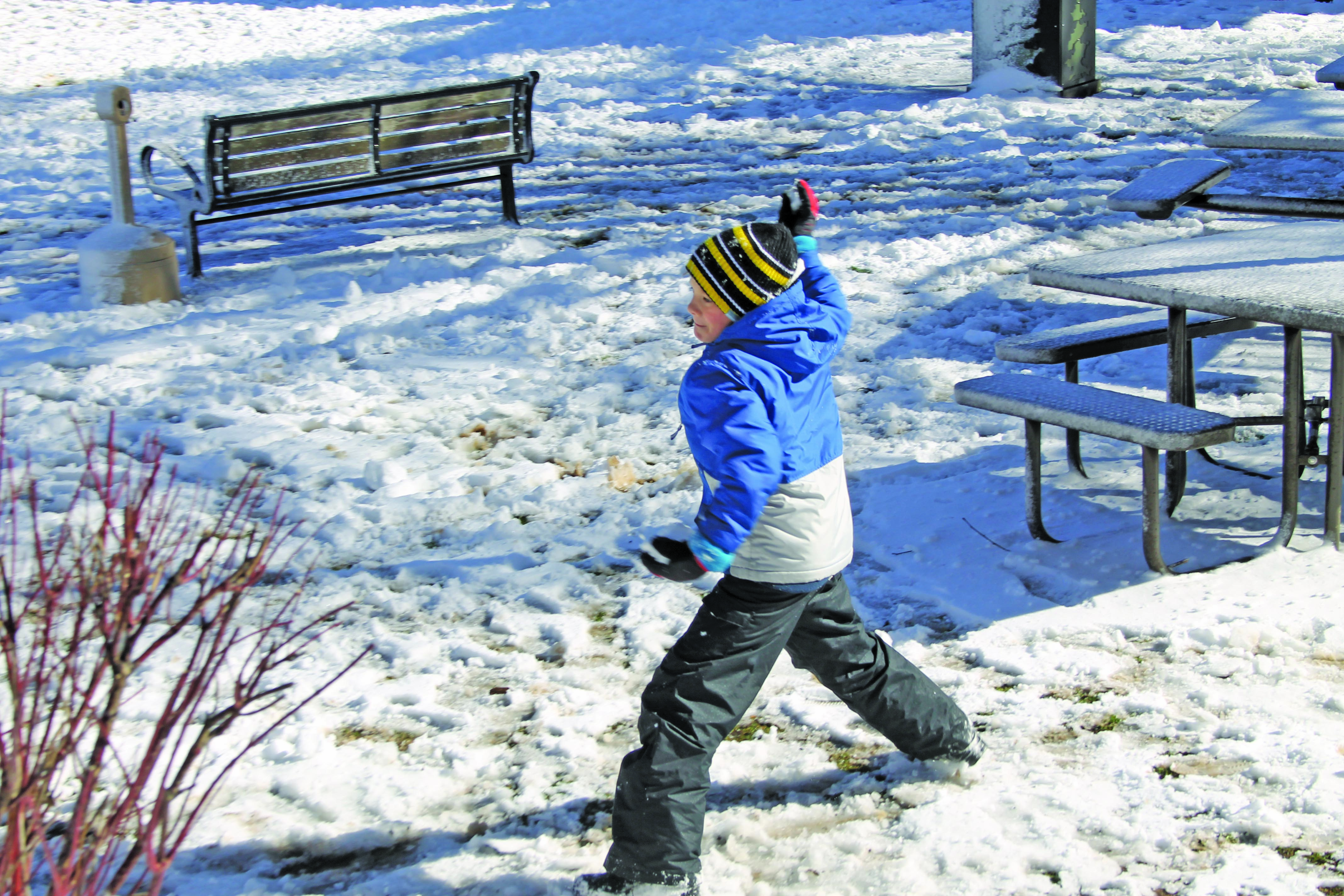 Photo by Christopher Lugo/Staff Highlands school student Walker Kitrell throws a snowball at Kelsey Hutchinson Founder’s Park on Monday. 