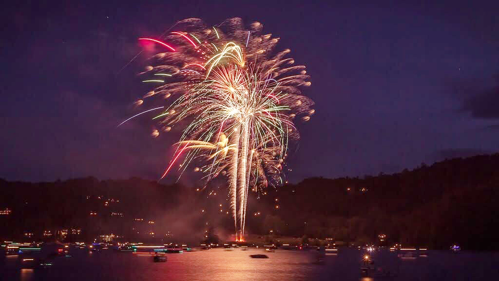 Fireworks erupt over Lake Glenville while boats watch from the water during a previous Fireworks Over Lake Glenville celebration. Photo courtesy of Friends of Lake Glenville