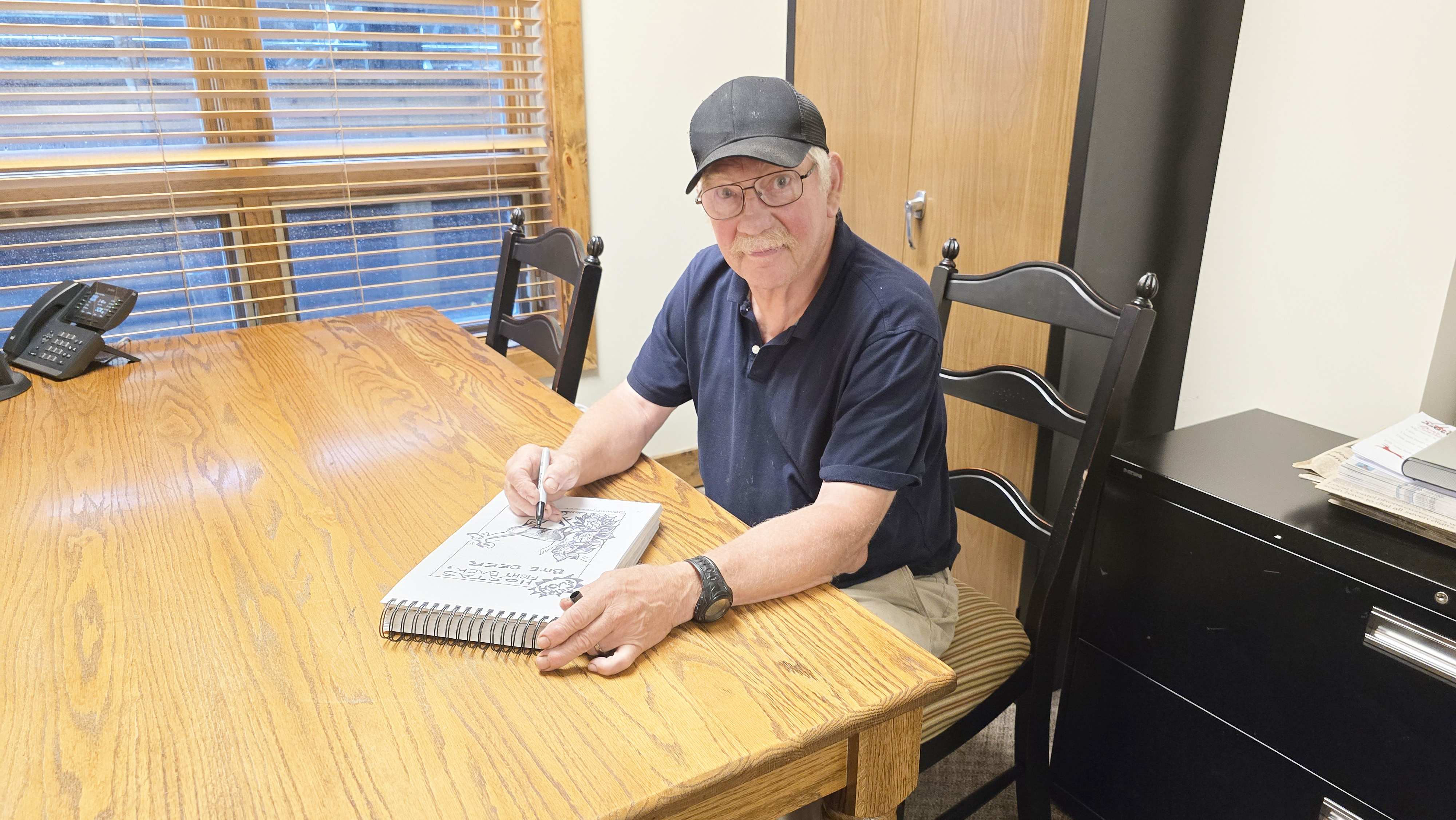 Duncan Greenlee works on the cartoon for the July 16 edition of The Highlander. Greenlee has been drawing for paper since 1986.