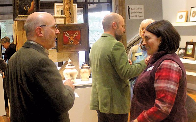 Highlands Biological Station Executive Director Jim Costa and Highlands Chamber of Commerce board chair Hilary Wilkes discuss upcoming initiatives during a community partners event at The Bascom Center for the Visual Arts on Monday night.