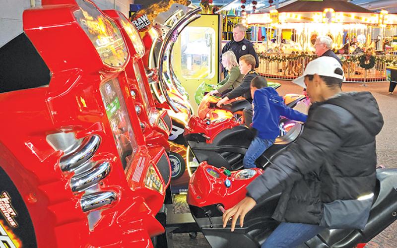 Children from Highlands enjoyed some arcade games at the Fun Factory in Franklin as part of the Shop with a Cop program.