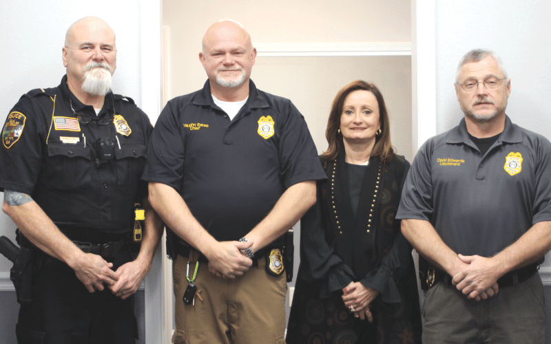 Lt. Ron Baumes, Vaughn Estes, chief of police, Ella Fast, city manager and Lt. David Edwards stand inside the newly renovated Sky Valley Police Department during a Dec. 19 open house.