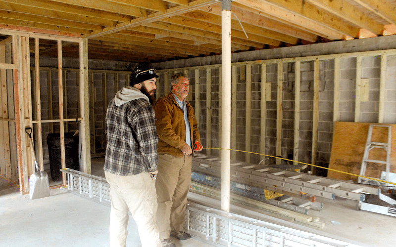 Ray Davis, of Northeast Georgia Heating and Air takes measurements of the potential retail space in a building being renovated on Fifth Street in downtown highlands.