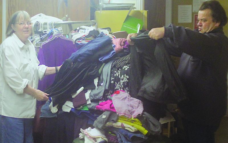 Volunteers Marie Johnson and Ray Such sort through donated items at the Highlands Emergency Council on Jan. 2.