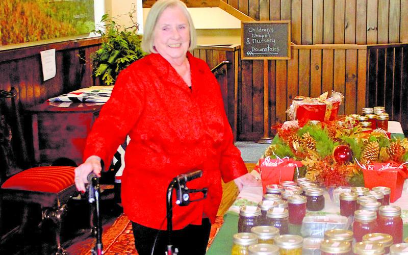 Mary Ann Creswell sets up a table following the Highlands Christmas Parade at the Church of the Incarnation.
