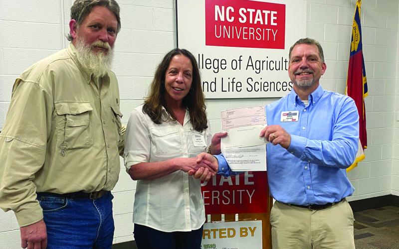 Lori and Daniel Cabe are presented their grant award from Ross Young, WNC AgOptions steering committee leader.