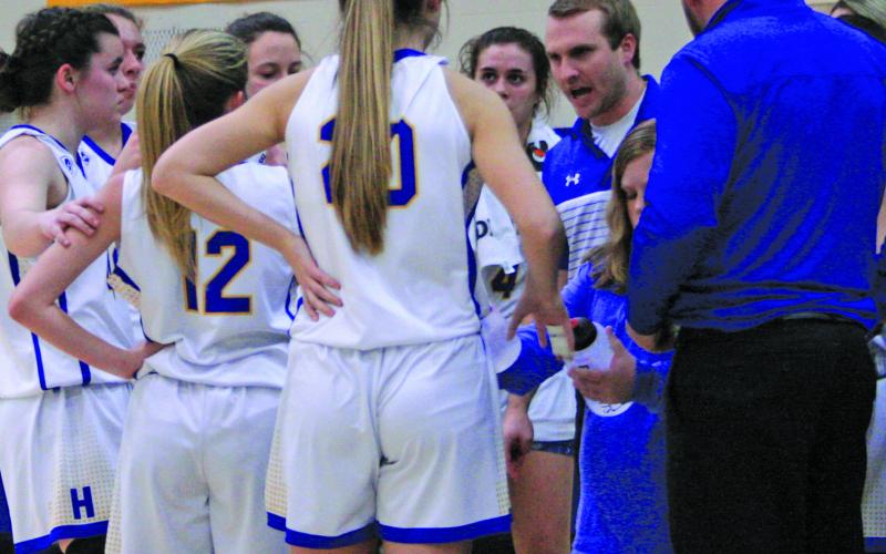 HHS girls basketball coach Jacob Page talks to his team during the first round of the NCSHAA 1-A playoffs in March.