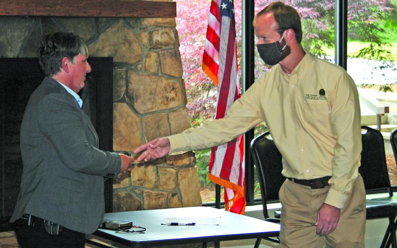 Highlands Police Chief Andrea Holland is presented with her new badge by town manager Josh Ward following a swearing-in ceremony on Thursday.