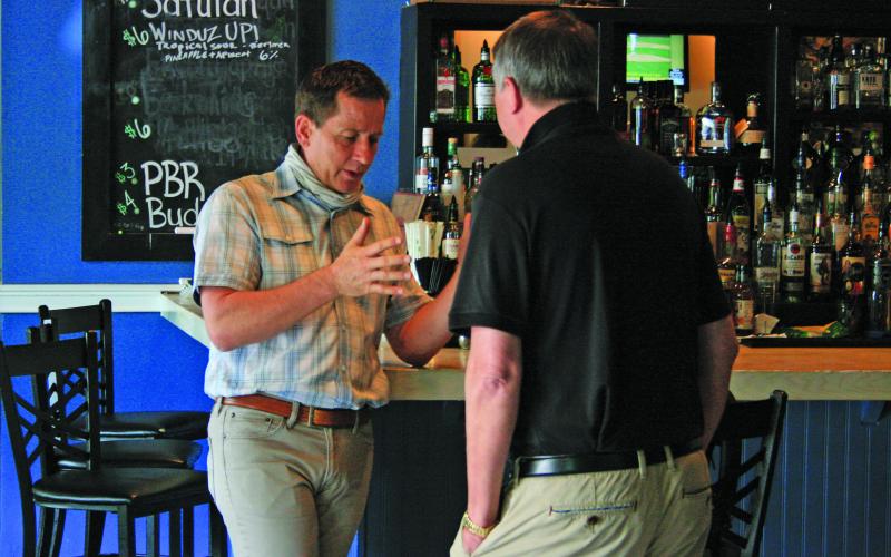 Michael Honig, of Honig Vineyard and Winery, goes over the wine-making process with a guest during a luncheon at 4118 Kitchen and Bar on Friday afternoon.