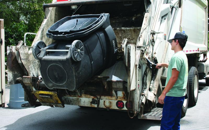 The new bear-resistant garbage cans can be dumped using a lift arm on the trash truck itself, which eliminates the manual lifting of non-compliant cans.