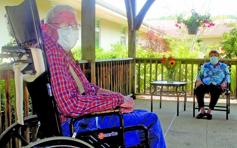 Eckerd Living Center resident Sherman Runion, 75, meets with Mary Jo, his wife of 52 years, during a visit in the living center’s garden last week.