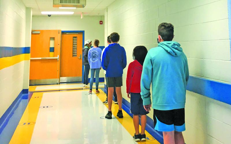 Students wait to receive a COVID-19 test at Highlands School. The testing program is being administered by the Highlands Cashiers Health Foundation.