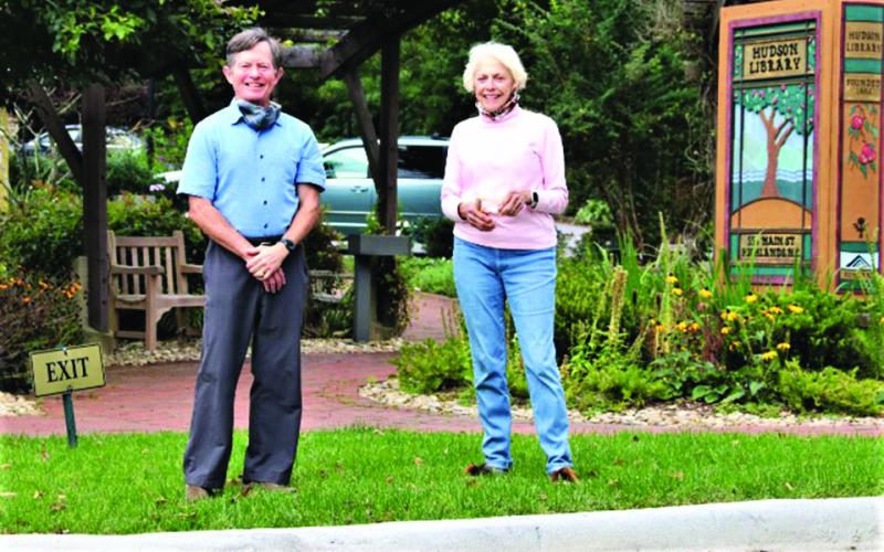 Andy Chmar, president of the Hudson Library board, and Glenda Bell, president of Mountain Findings, admire the handiwork performed on the Hudson Library’s Main Street entrance that has experienced drainage issues for years.