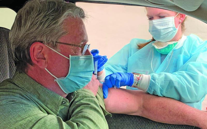 Dr. Donald Dewhurst received his COVID-19 vaccine from nurse Ruthie Capaforte at Macon County Public Health on Dec. 31.