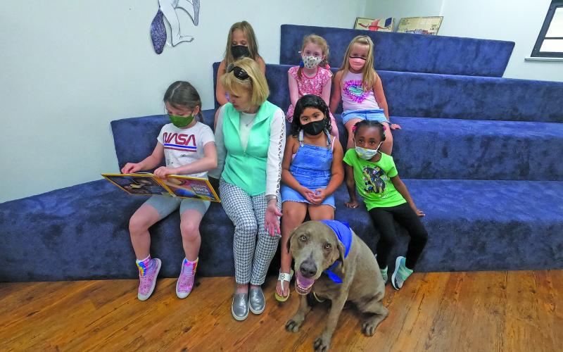 Photo by Christopher Smith/Staff   Ben the reading dog helps students gain confidence in their reading skills.