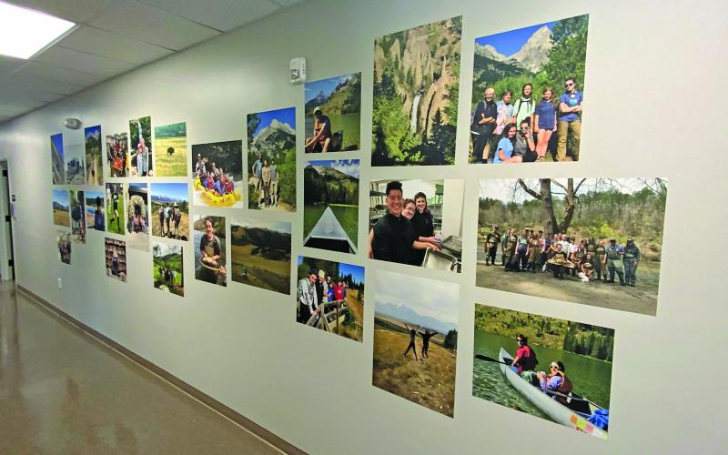 Photo by Christopher Smith/Staff A hallway in the new high school building is filled with photos of students getting field experience and volunteering.