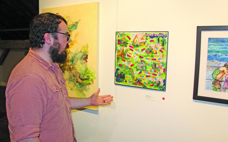 Photo by Christopher Smith/Staff  Zach Rogers explains the PLAY! exhibit.