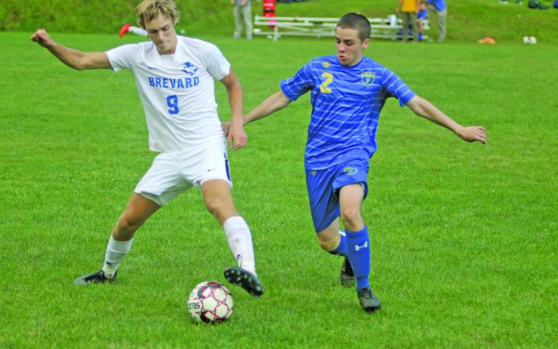 Photo by Christopher Smith/Staff Inman Ahrens fights for the ball against a Brevard forward in the Highlanders opening match.
