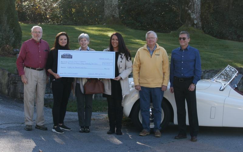 Photo by Ryan Hanchett/Staff Steve Mehder, Cindy Trevathan, Linda Edwards, Bonnie Potts, Mark Chmar and Knight Martorell presenting the check to the Literacy Council of Highlands, REACH of Macon County and the Community Care Clinic.
