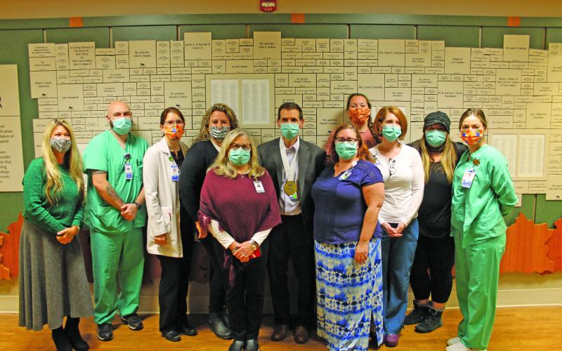 Photo by Christopher Smith/Staff Highlands-Cashiers Hospital staff surprised CEO Tom Neal with the NCHA Healthcare Hero Award last Friday.