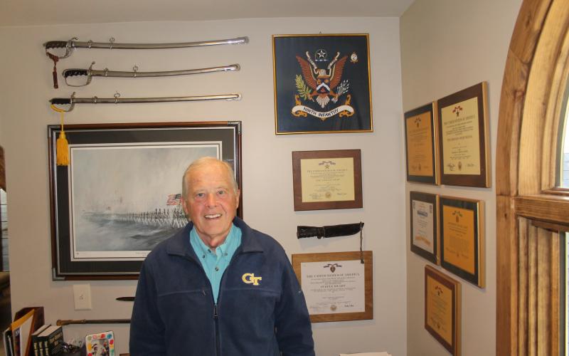 Photo by Christopher Smith/Staff The newest member of American Legion Post 370, Vietnam veteran Rick St. John infront of war memorabilia at his home.
