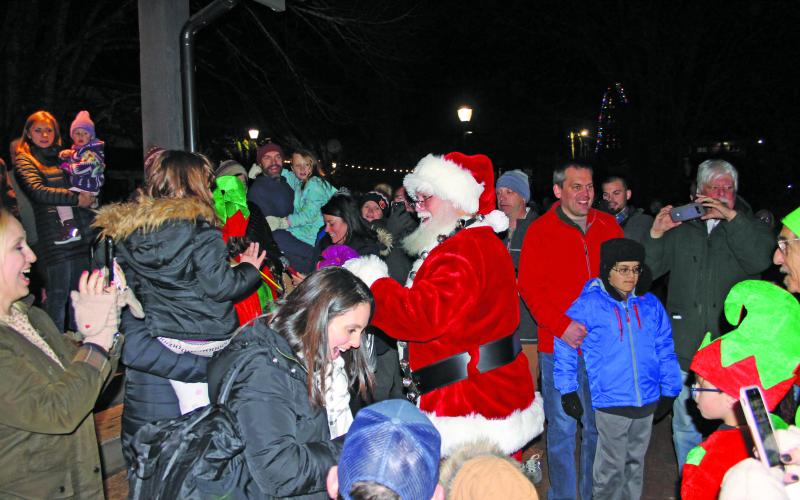 Santa Claus making his way to the stage.