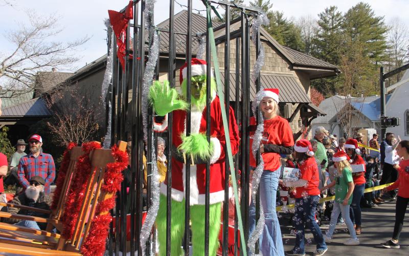 Photo by Christopher Lugo/Staff The Grinch behind bars during the Christmas Parade.
