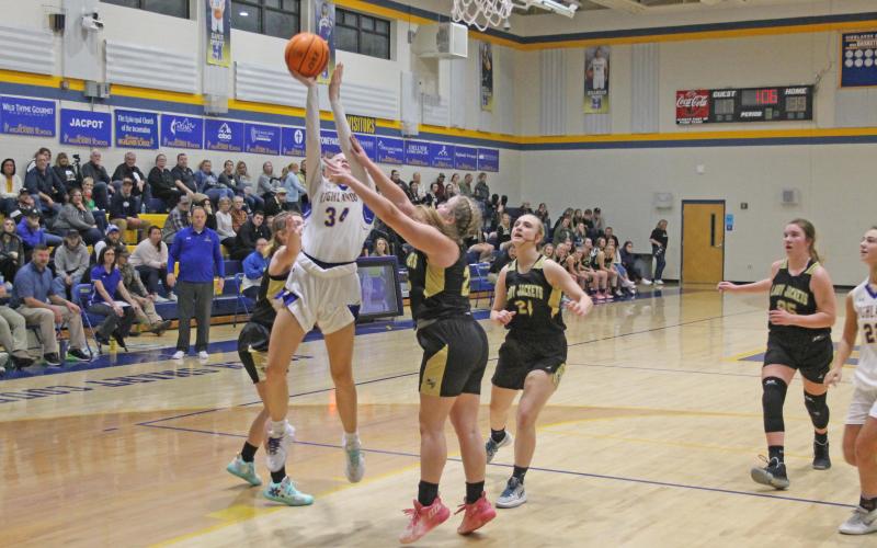 Photo by Christopher Lugo/Staff HHS junior Bella Wilson fights for a layup in the Lady Highlander’s win against Hayesville, Friday night.