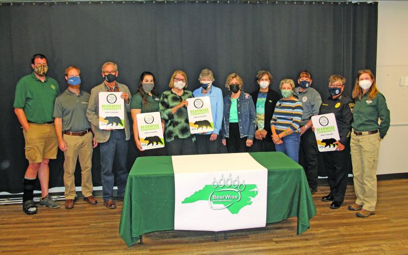 Photo by Christopher Lugo/Staff In October, representatives from the N.C. Wildlife Resources Commission presented town officials and the BEAR task force with official signs and pins confirming the town’s BearWise certification.