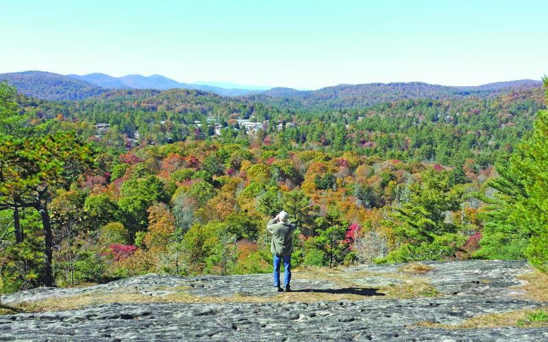 Photo by Pam Kolber/STaff Chet Kolber takes a picture at the edge of Sunset Rock, which is owned by the Highlands Cashiers Land Trust.