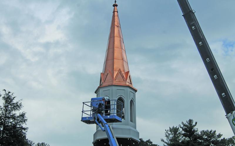 Photo by Christopher Lugo/Staff The copper plated steeple being placed back in September 2021.