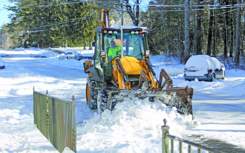 Road crews are still at work plowing snow out of the streets. Photo by Christopher Lugo/Staff