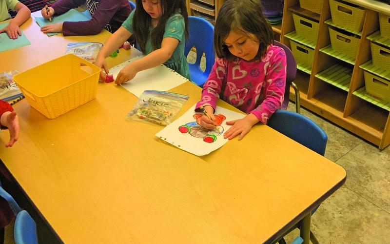 Photo by Christopher Lugo/Staff Students at Highlands Community Child Development Center colors a picture.