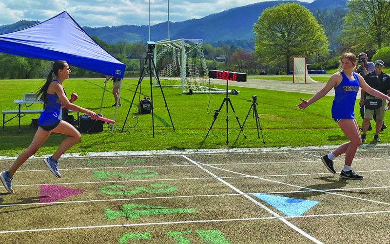 Photo by Jody Pierson/Staff Highlands’ Margaret Cole hands off the baton to teammate Nicole Taylor during the Tri-State Middle School Track Championship at Rabun Gap on Saturday. Highlands and Tallulah Falls battled back and forth to the final event in the team competition.