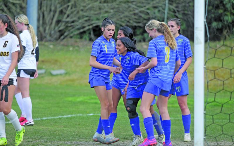 Photo by Christopher Lugo/Staff Highlands freshman Gabriela Diaz gets help from her teammates after scoring a goal on Monday night.