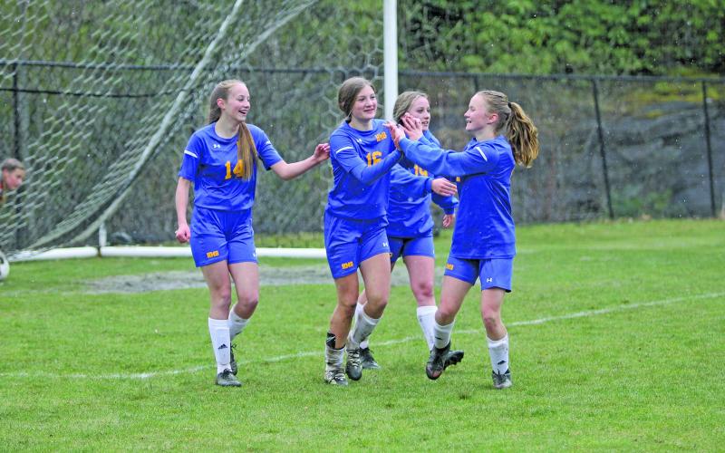 Photo by Christopher Lugo/Staff Kayden Pierson, Claire Worley and Anne Elizabeth Woods congratulate Charlotte Westendorf after a goal on Friday afternoon.