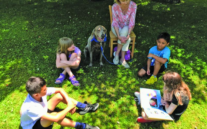 Submitted Photo Children reading outside during last year’s summer camp at The Literacy and Learning Center.