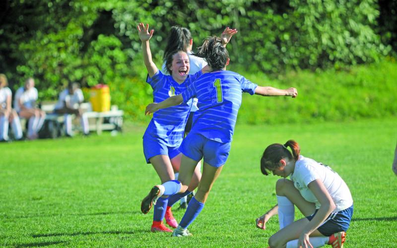 Photo by Christopher Lugo/Staff Senior Reese Schmitt congratulates sophomore Aislynn Luck after her goal against Queens Grant.