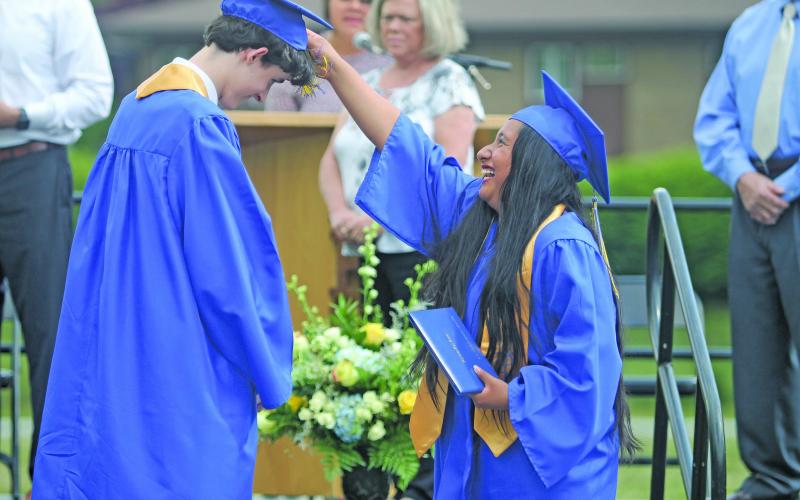 Photo by Christopher Lugo/Staff Highlands graduate Ruth Mendoza-Hernandez turns the tassel of fellow classmate, Liam Kennedy.