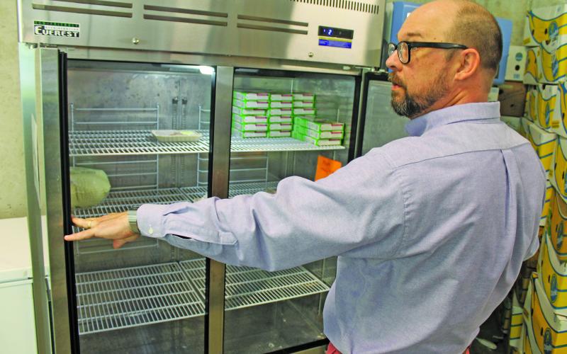 Photo by Christopher Lugo/Staff IFC executive director T.J. Smith showcased the lack of chicken in the Highlands Food Pantry freezer.