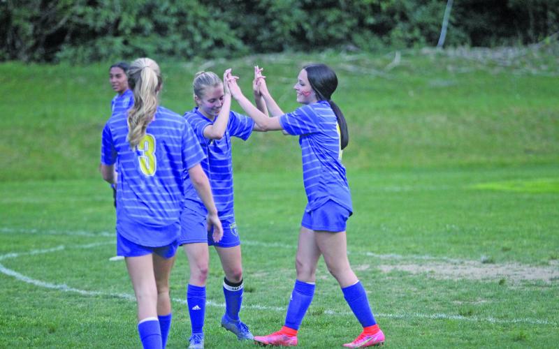 Photo by Christopher Lugo/Staff Highlands seniors Hayley Borino and Reese Schmitt high-five after a goal against Hayesville.